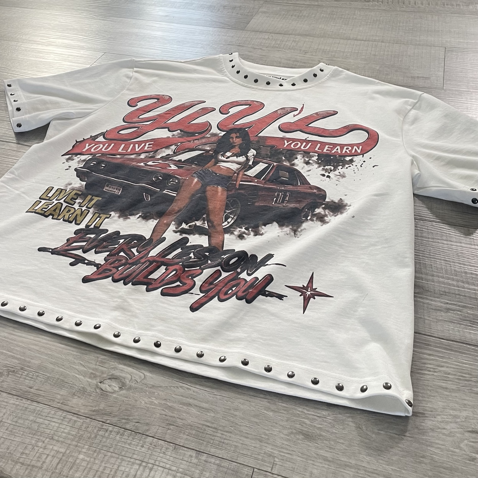 Angled close detail of the shirt artwork and studs