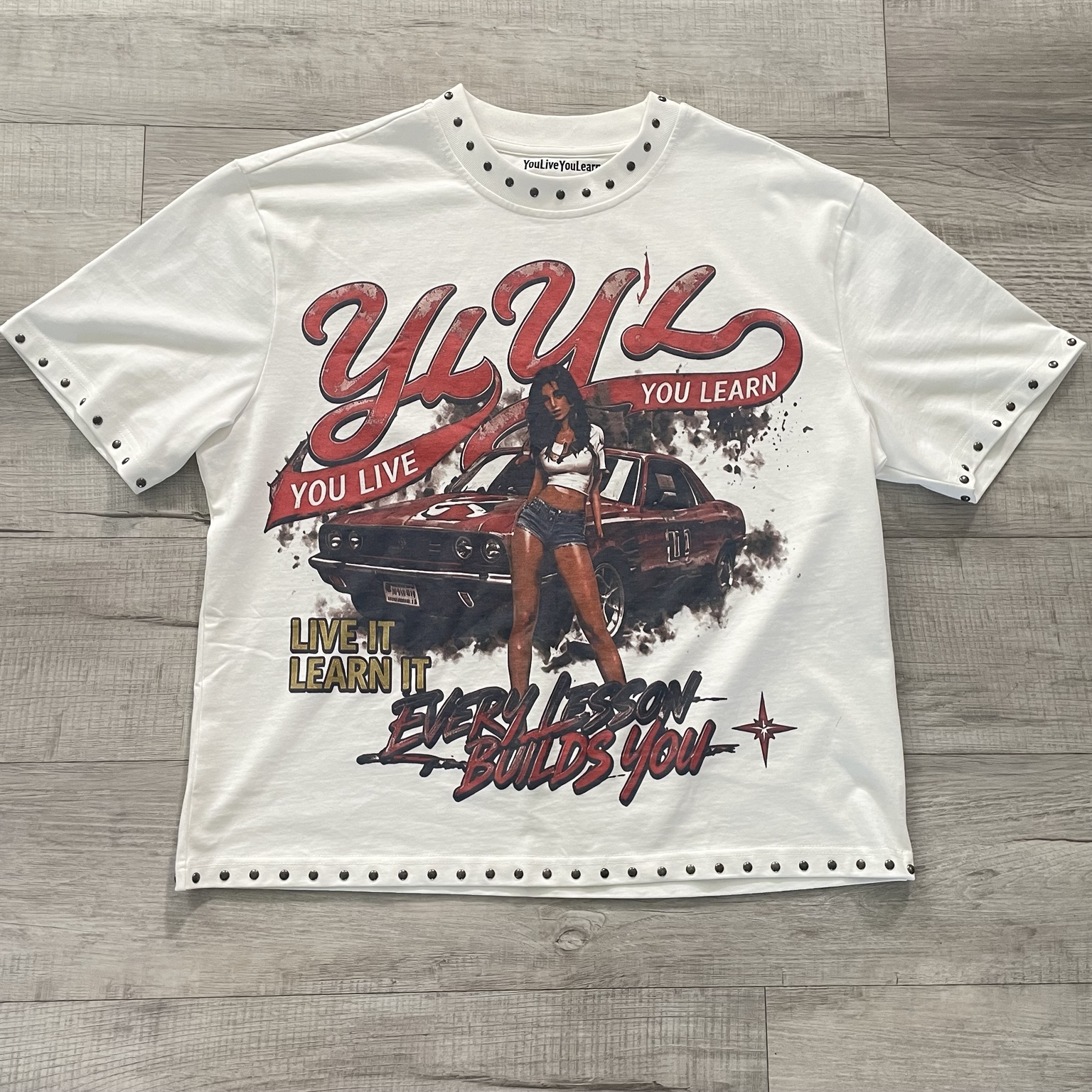 Front of the YouLiveYouLearn white studded graphic tee